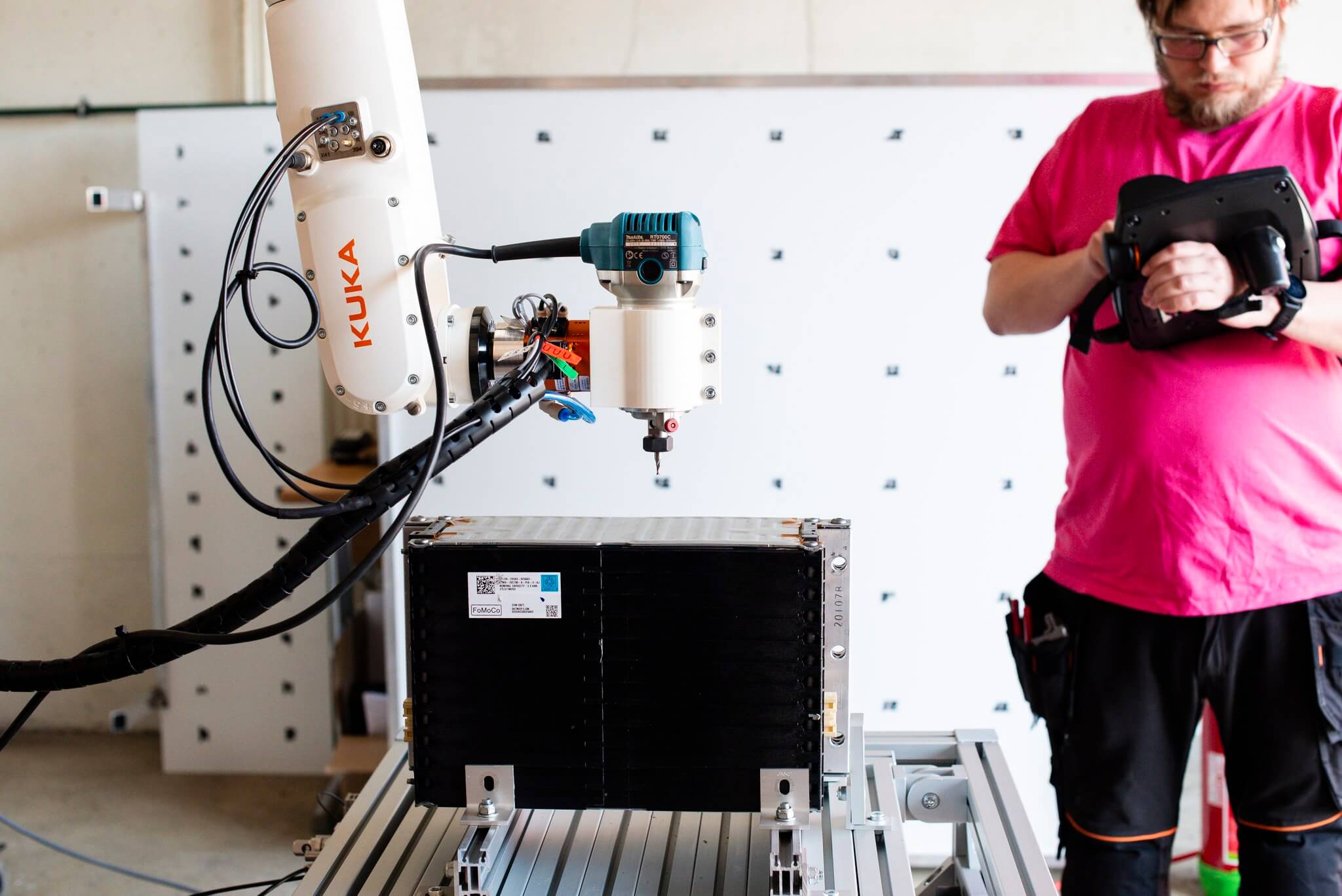 Our robotics expert Kari programming a robot that disassembles electric car batteries in the Recirculate project