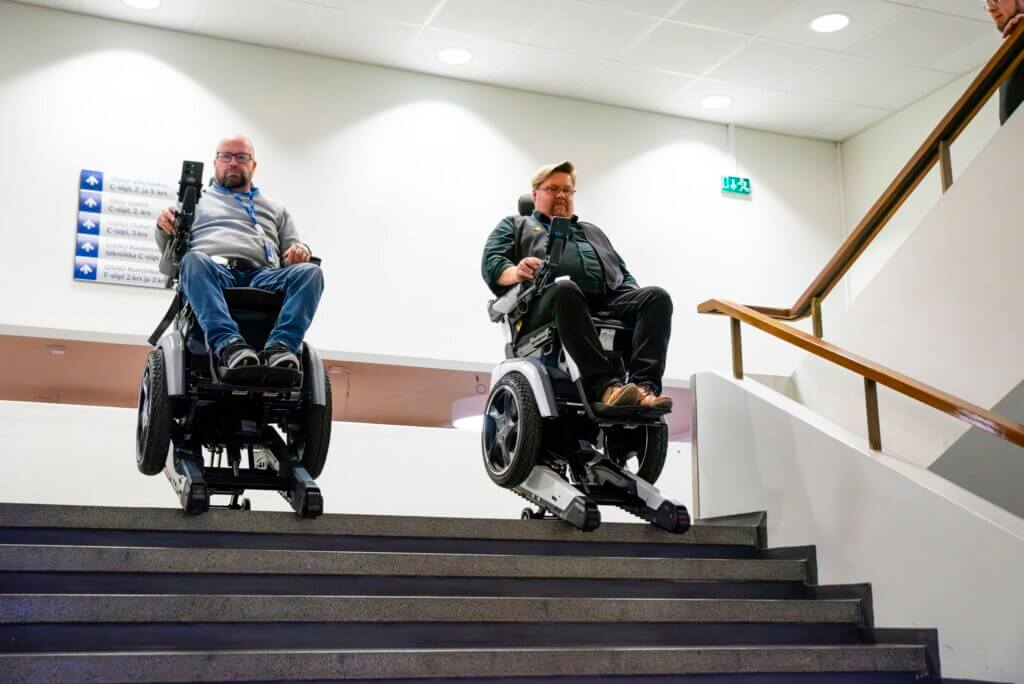 During user training practicing descending stairs with Scewo BRO electric wheelchairs.