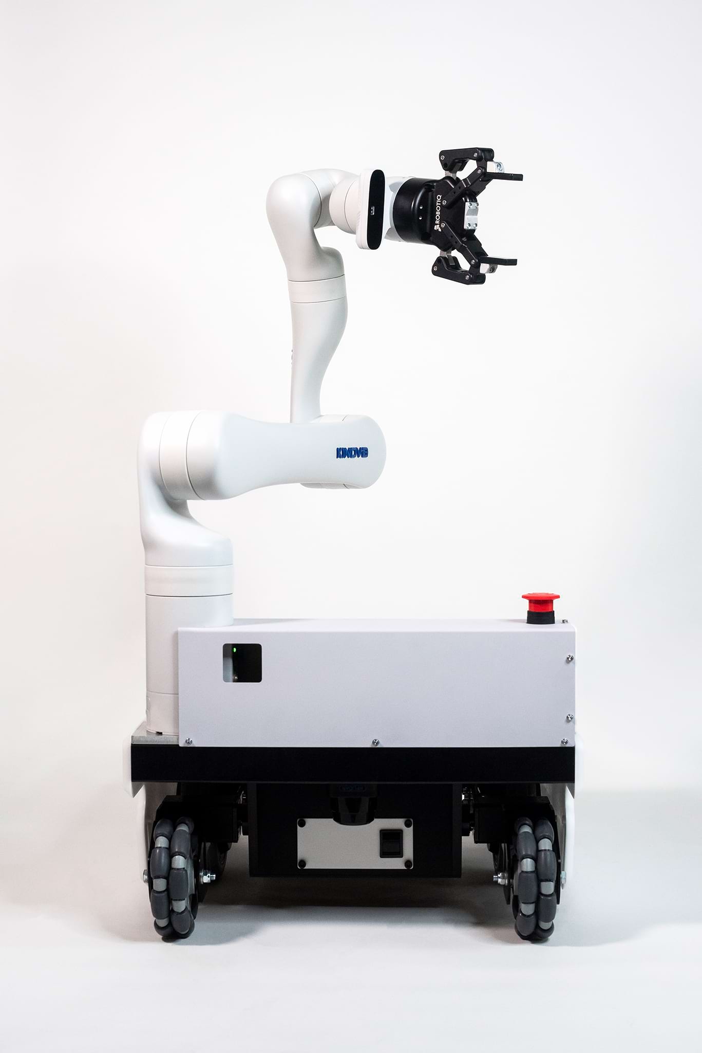 A white mobile robot on wheels with a white robotic arm with and a black gripper.