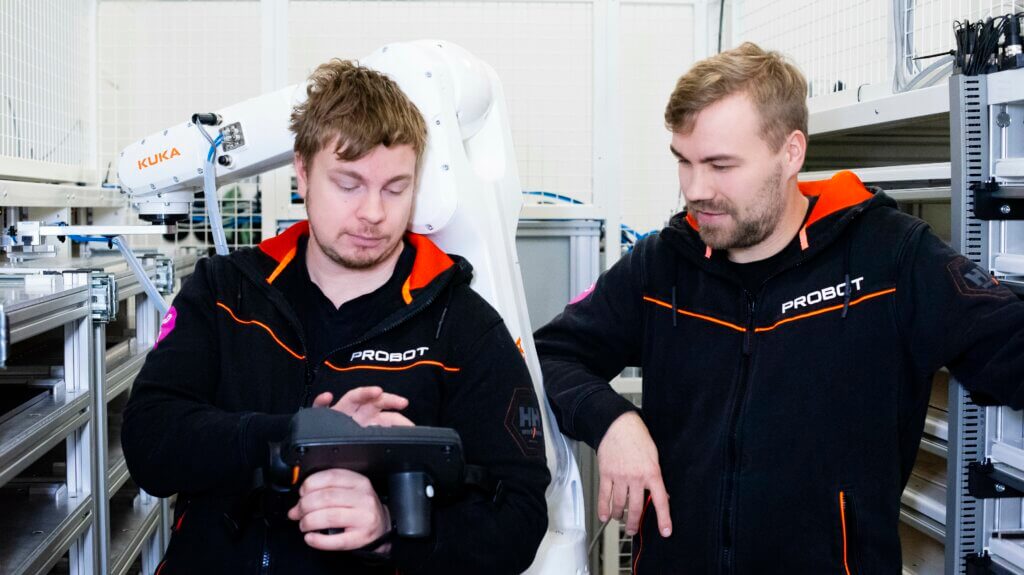 Probot's robotics experts studying the robot controller and keeping ESG goals in mind. How Can Robotics Support Environmental Responsibility?