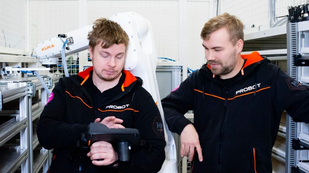 Probot's robotics experts examine the robot's controller
