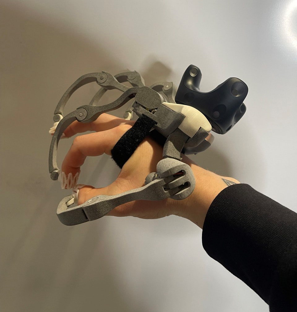 Human hand with haptic glove attached to it.