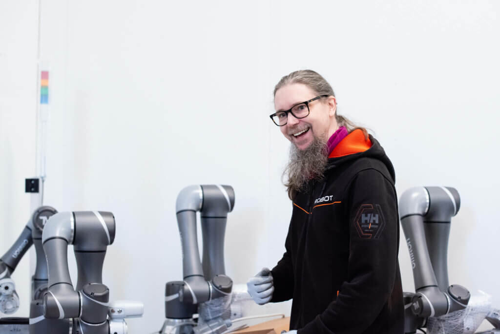Our automation engineer Jani Juntikka in our warehouse, unpacking Omron's collaborative robots.
