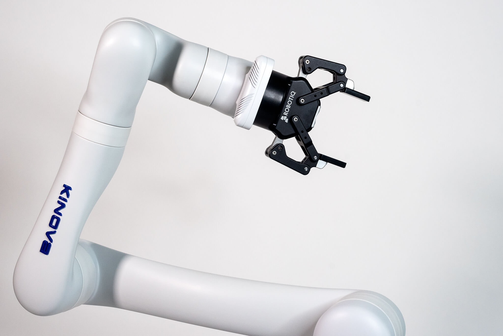 Close-up of a white robotic arm and a black gripper.