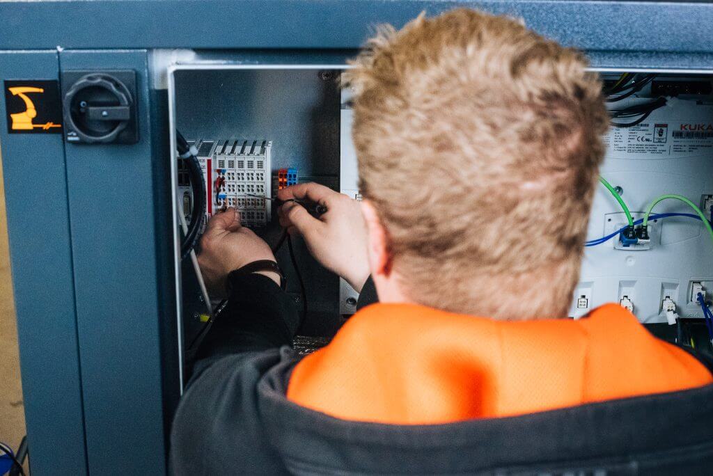 An employee connects wires.