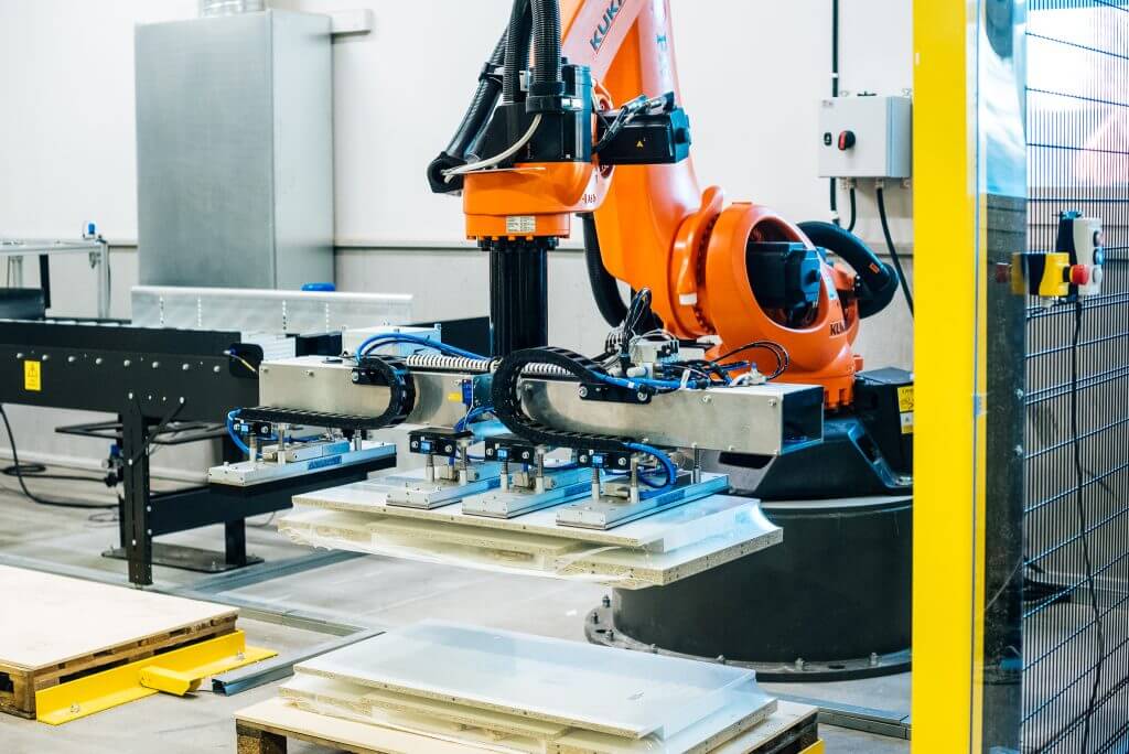 KUKA industrial robot palletising at a factory.