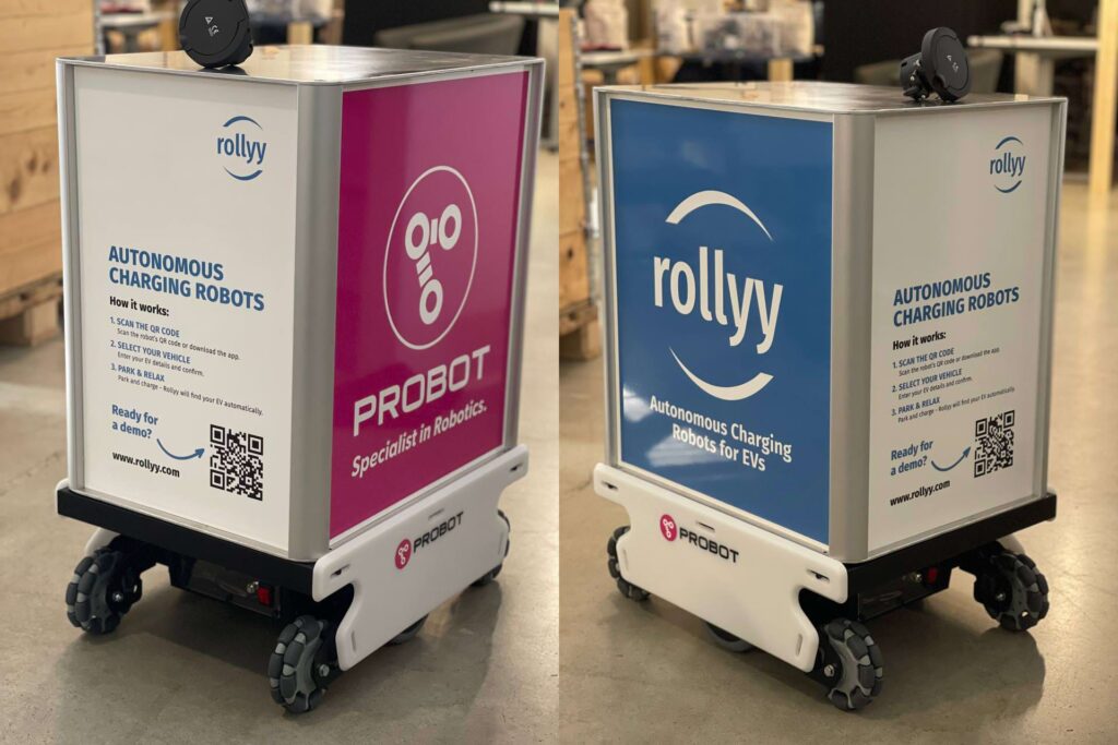 The image shows two mobile robots, each equipped with an intelligent electric vehicle charging system. One charging box is labeled Probot Oy, and the other Rollyy.