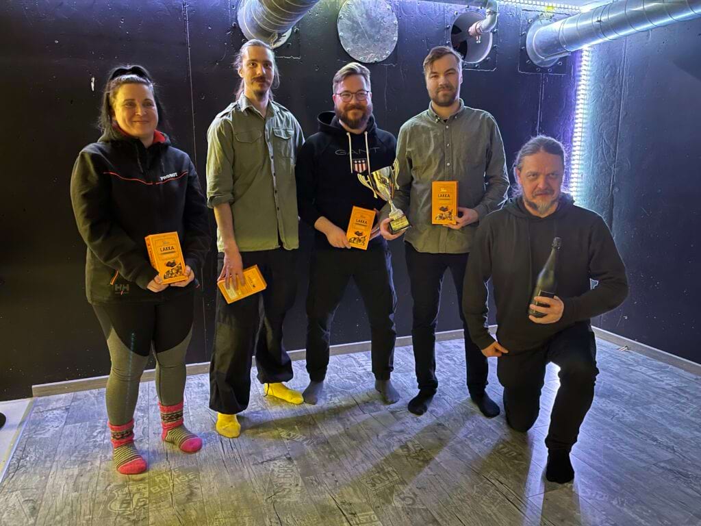 Five colleagues pose with the awards, happy to win.
